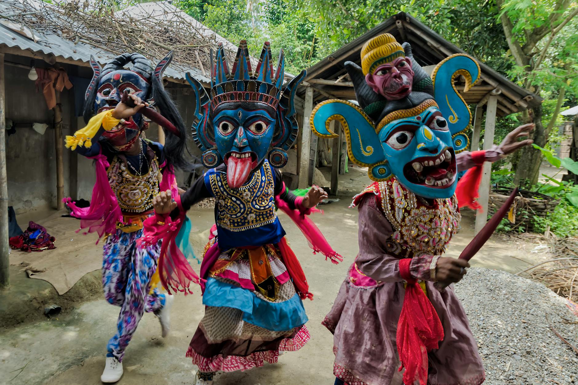 Tancerze ludowi w kolorowych maskach i strojach w Zachodnim Bengalu